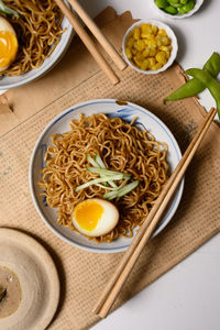 High angle view of noodles with egg served on table