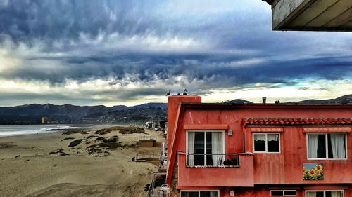 Houses against cloudy sky