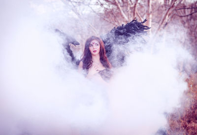 Close-up of beautiful young woman wearing angel costume