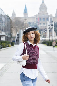 Portrait of teenage girl standing in city