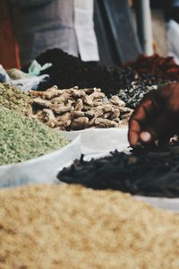 Cropped hand holding spice at market stall