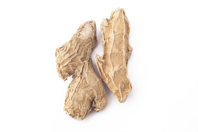 Close-up of dried leaves over white background