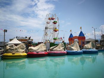 Boats moored in water against sky