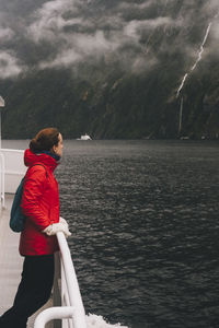 Side view of man looking at sea