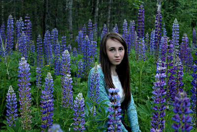 Portrait of young woman by purple flowers