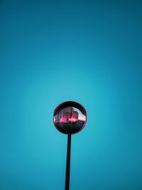 Low angle view of street light against clear blue sky