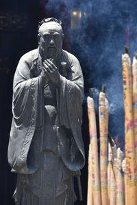 Statue of buddha against temple