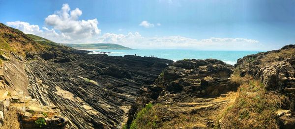 Panoramic view of sea and mountains against sky