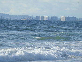 Scenic view of sea and buildings against sky