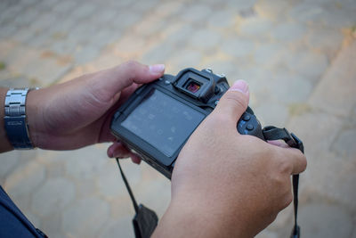Close-up of person photographing camera on mobile phone