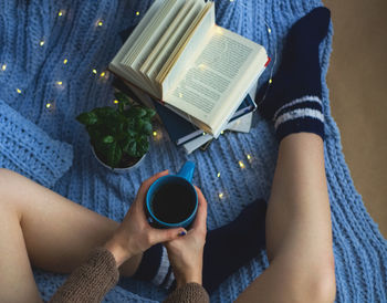 Low section of woman holding coffee cup