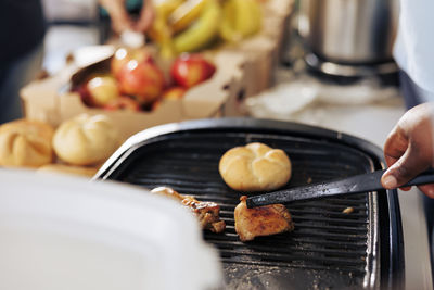 Cropped hand of man preparing food