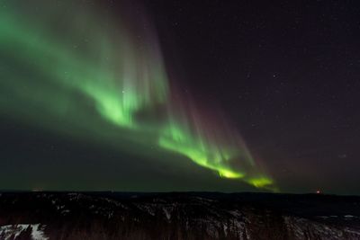 Scenic view of landscape against sky at night