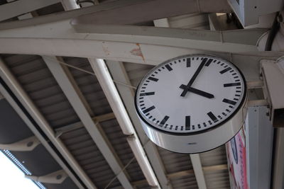 Low angle view of clock hanging on ceiling