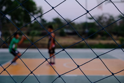 Close-up of chainlink fence against sky