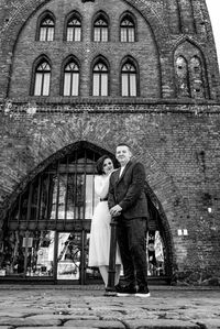 Full length of couple kissing in front of building. wedding in the old town