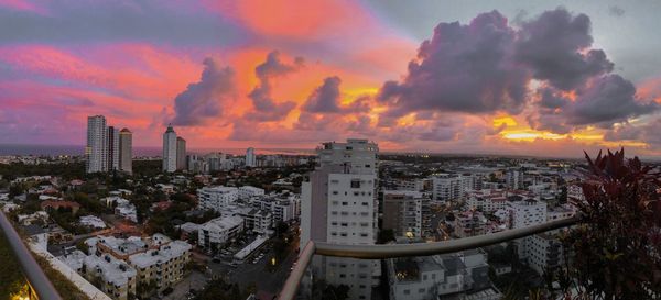 High angle view of modern buildings against sky during sunset