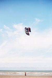 People on beach against sky