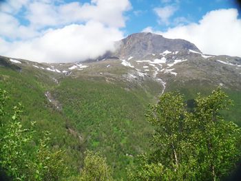 Scenic view of mountains against cloudy sky