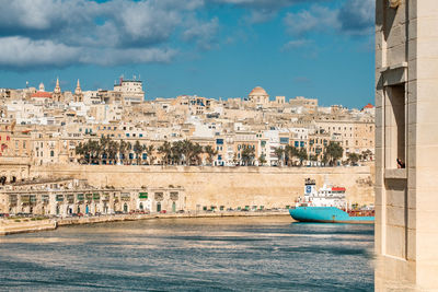 Valletta skyline with port and old cargo ship, blue sky and sea