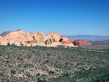 Scenic view of desert against clear blue sky