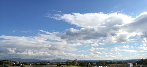 Panoramic view of city against blue sky