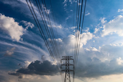 Low angle view of electricity pylon against sky