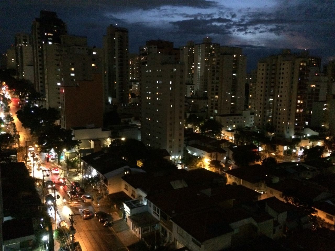 AERIAL VIEW OF ILLUMINATED CITY BUILDINGS AT NIGHT