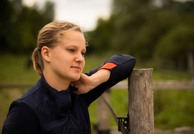 Portrait of young woman looking away outdoors