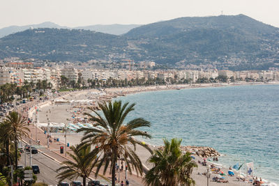 High angle view of city by sea against sky