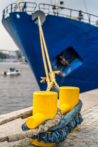 Close-up of yellow moored on pier
