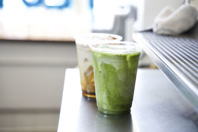 Close-up of iced latte and matcha tea latte on the counter of a coffee shop in los angeles, ca