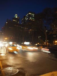 Illuminated city street at night