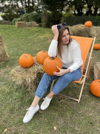 Rear view of woman sitting on grassy field