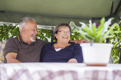 Cheerful couple sitting on seat