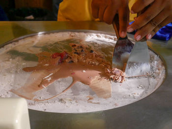 Close-up of person preparing food on table