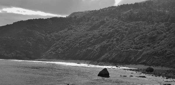 Scenic view of sea against mountains