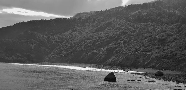 Scenic view of sea against mountains