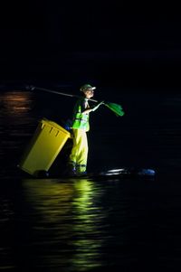 Man working in water at night