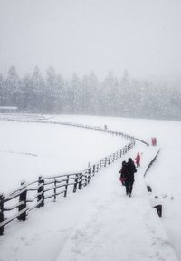 Scenic view of snow covered field against sky