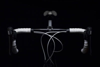 Close-up of bicycle against black background