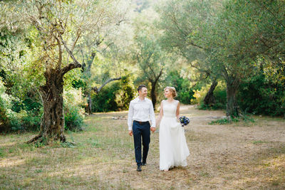 Full length of couple walking in forest