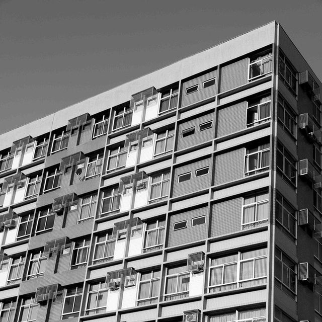 architecture, building exterior, built structure, low angle view, window, building, clear sky, residential building, city, residential structure, apartment, in a row, modern, balcony, sky, no people, day, outdoors, repetition, office building