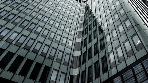 Low angle view of modern glass building in city