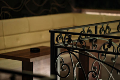 Close-up of railing against table at home