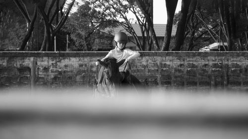 Girl riding horse outdoors