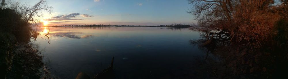 Scenic view of lake against sky during sunset