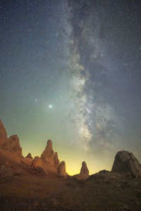 Scenic view of rock formation against sky at night