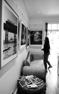 Young woman looking through window