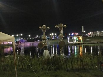 Reflection of illuminated built structures in water at night